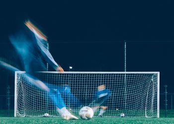 timelapse photo of soccer player kicking ball