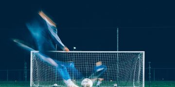 timelapse photo of soccer player kicking ball
